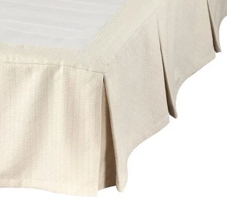 Close-up of a beige tablecloth draping over a table corner.