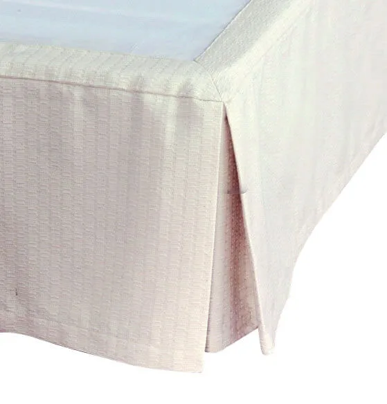 A plain white textured tablecloth on a rectangular table against a white background.