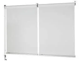 Two white roller blinds mounted on a white wall.